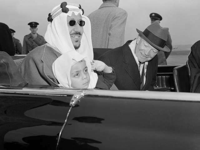 Six-year-old Prince Mashhur ibn Saud waves as he sits on the lap of his father, King Saud of Saudi Arabia, and beside President Eisenhower as they left National Airport, January 30, 1957.  The King and his official party will visit here three days for talks with the President.