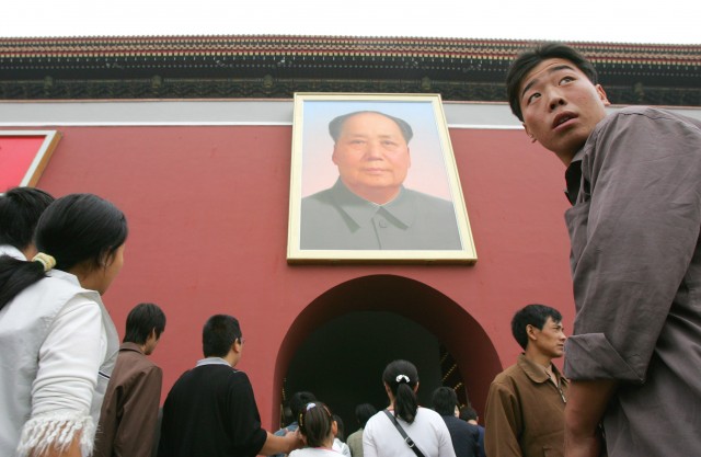 Visitors walk below the portrait of late communist leader Mao Zedong at Beijing's Tiananmen Gate on China's National Day, Saturday, Oct. 1, 2005. Thousands flocked to Tiananmen Square to celebrate the 56th anniversary of Mao's founding of communist China on October 1, 1949. 