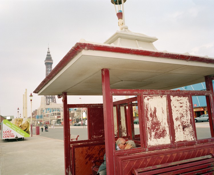 An elderly couple kiss in a weather shelter on Blackpool promenade. The town has for a long time been a destination for those in or looking for love.