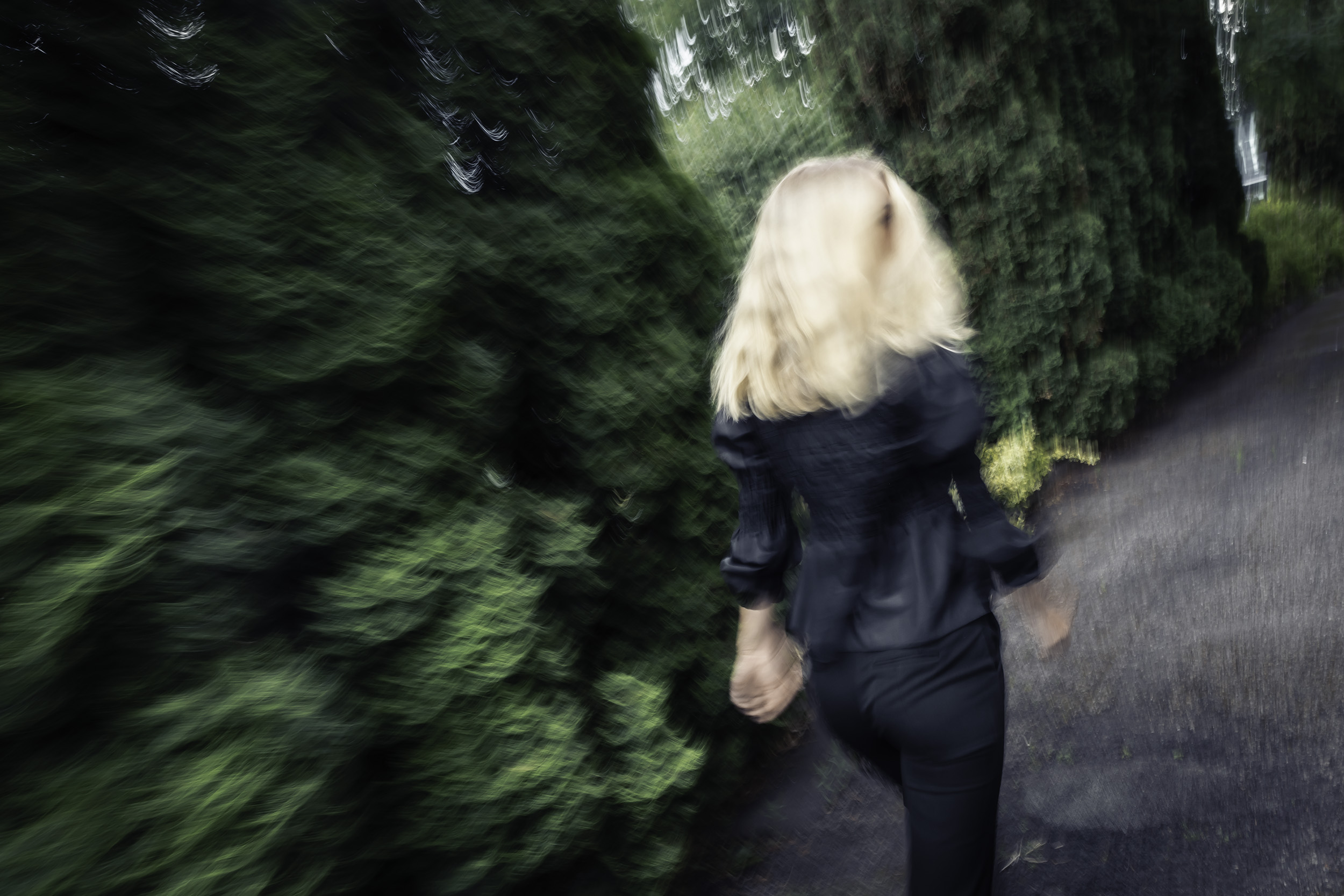 Bildet viser en blond kvinne som løper fra kamera. Hun ser seg over skuldra, men man ser ikke ansiktet hennes.